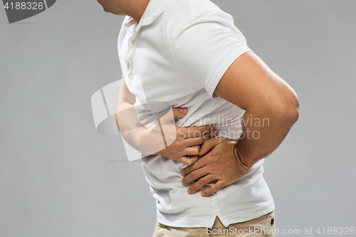 Image of close up of man suffering from pain in side