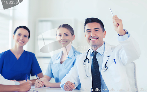 Image of group of happy doctors on conference at hospital