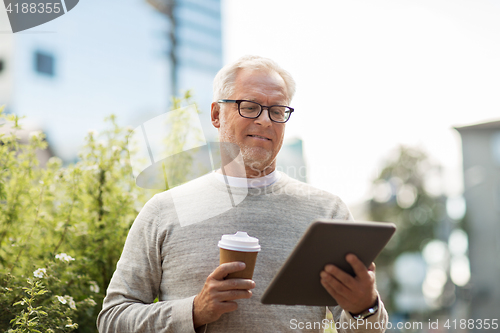 Image of senior man with tablet pc and coffee in city