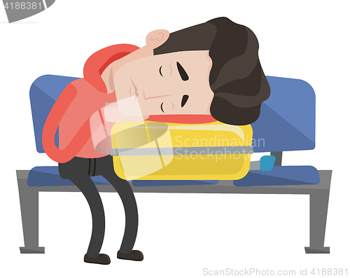 Image of Exhausted man sleeping on suitcase at airport.