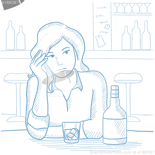 Image of Woman drinking alcoholic drink at the bar.