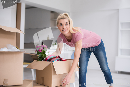 Image of girl moving in the new apartment