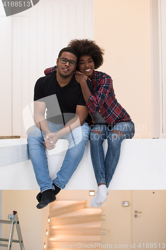 Image of couple having break during moving to new house