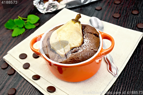 Image of Cake chocolate with pear in red bowl on napkin