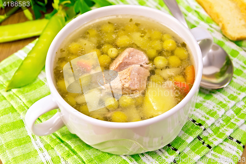 Image of Soup from green peas with meat on napkin
