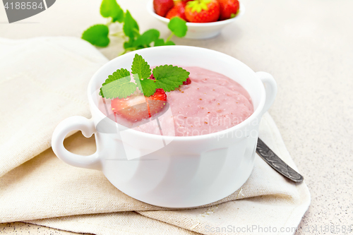 Image of Soup strawberry in white bowl on granite table