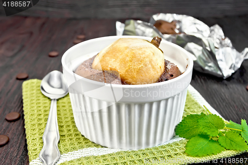 Image of Cake chocolate with pear in white bowl on green napkin