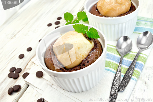 Image of Cake chocolate with pear and mint in white bowl on napkin