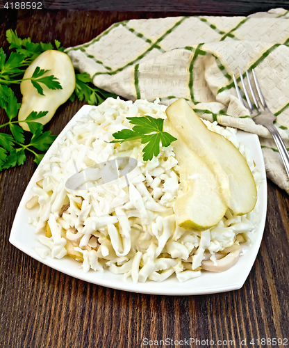 Image of Salad of squid and pears on dark board