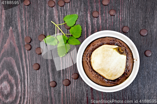 Image of Cake with chocolate and pear in white bowl on board top