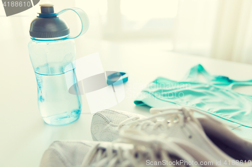 Image of close up of sportswear, bracelet and bottle