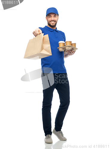 Image of happy delivery man with coffee and food in bag