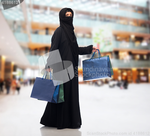 Image of muslim woman in hijab with shopping bags