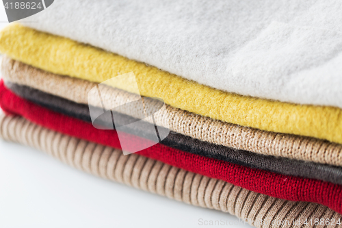 Image of close up of stacked knitted clothes