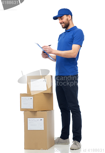 Image of happy delivery man with parcel boxes and clipboard