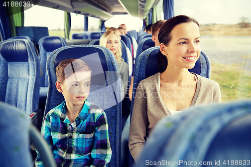 Image of happy family riding in travel bus