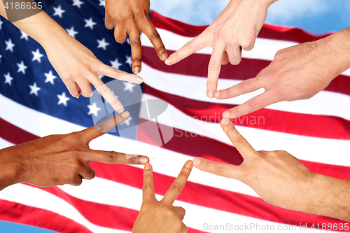 Image of group of international people showing peace sign