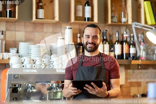 Image of man, barman or waiter with tablet pc at bar 