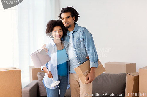 Image of happy couple with stuff moving to new home