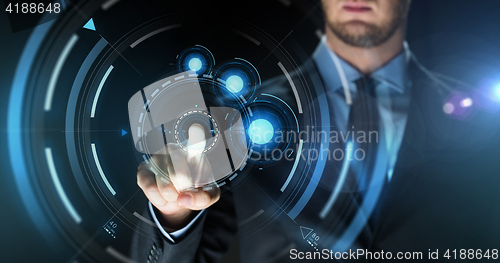 Image of businessman touching virtual screen projection