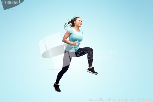 Image of happy smiling sporty young woman jumping in air