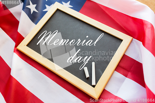 Image of memorial day words on chalkboard and american flag