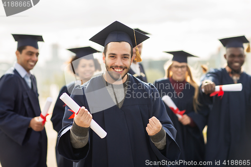 Image of happy student with diploma celebrating graduation