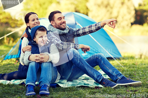 Image of happy family with tent at camp site