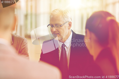 Image of smiling business people meeting in office