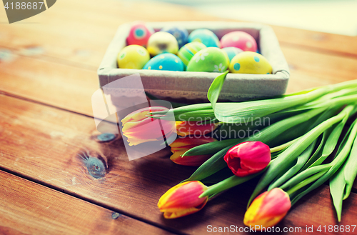 Image of close up of colored easter eggs and flowers