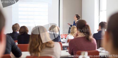 Image of Woman giving presentation in lecture hall at university.