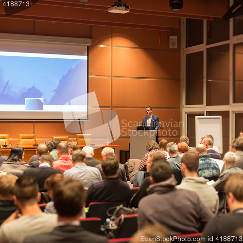 Image of Business speaker giving a talk in conference hall.