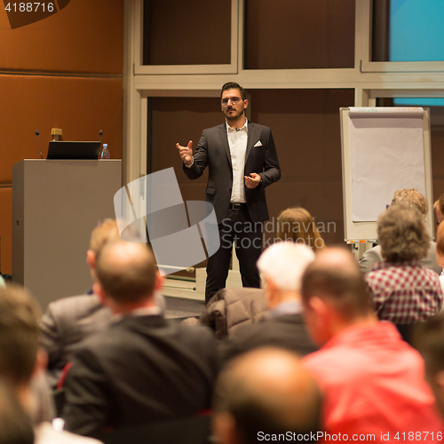 Image of Business speaker giving a talk in conference hall.