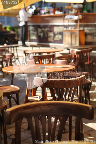 Image of empty little tables of cafeteria