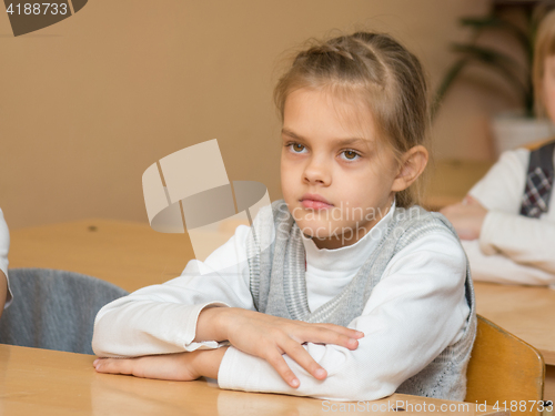 Image of Diligent student in the classroom listening to a teacher at school