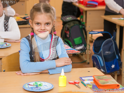Image of Happy first grader at a lesson in the school of technology, look in the frame