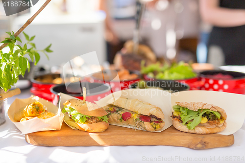 Image of Varieties of home made sandwiches beeing sold on street stall.