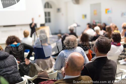 Image of Woman giving presentation in lecture hall at university.