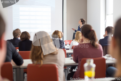 Image of Woman giving presentation in lecture hall at university.