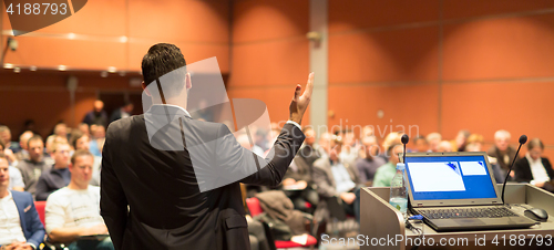 Image of Public speaker giving talk at business event.