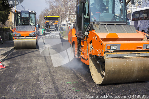 Image of Road roller compacting asphalt 