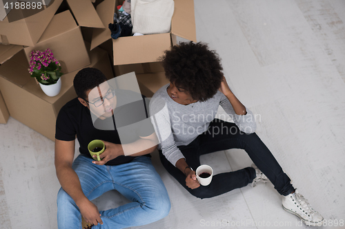 Image of African American couple relaxing in new house