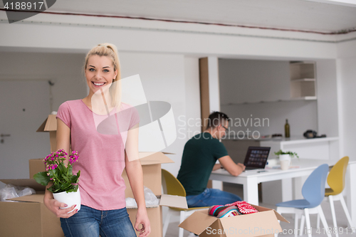 Image of young couple moving into a new home