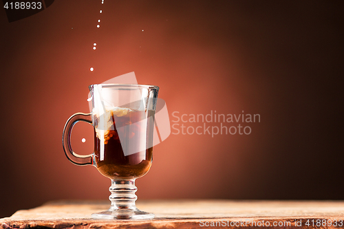 Image of Adding milk to a cup of coffee.