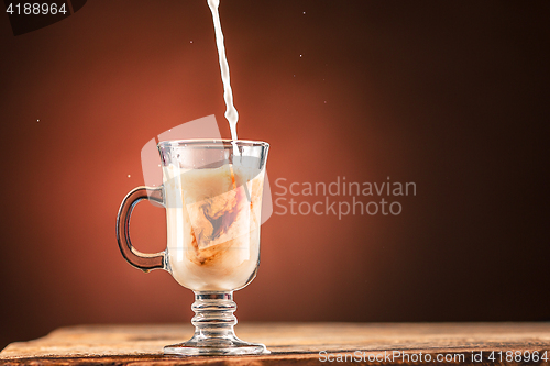 Image of Adding milk to a cup of tea