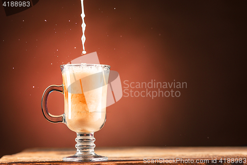 Image of Adding milk to a cup of coffee.