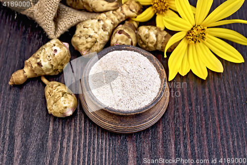 Image of Flour of Jerusalem artichoke in clay bowl on board