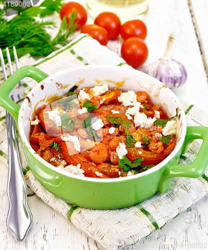 Image of Shrimp and tomato with feta in pan on light board