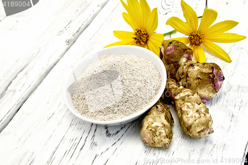 Image of Flour of Jerusalem artichoke in bowl with vegetables on light  b