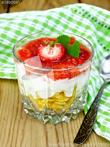 Image of Dessert milk with strawberry in glassful on wooden board